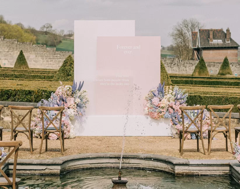 Wedding ceremony backdrop floral arrangement with Delphinium, Clematis Amazing®