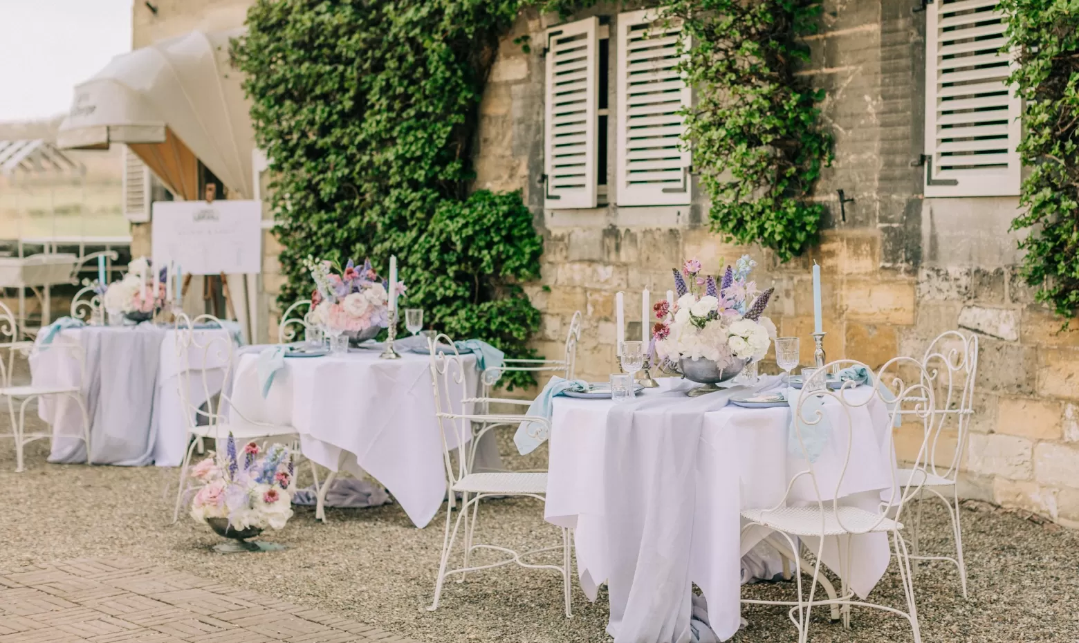 Wedding cocktail hour table arrangements, Clematis Amazing®, Delphinium, Scabiosa, Astilbe