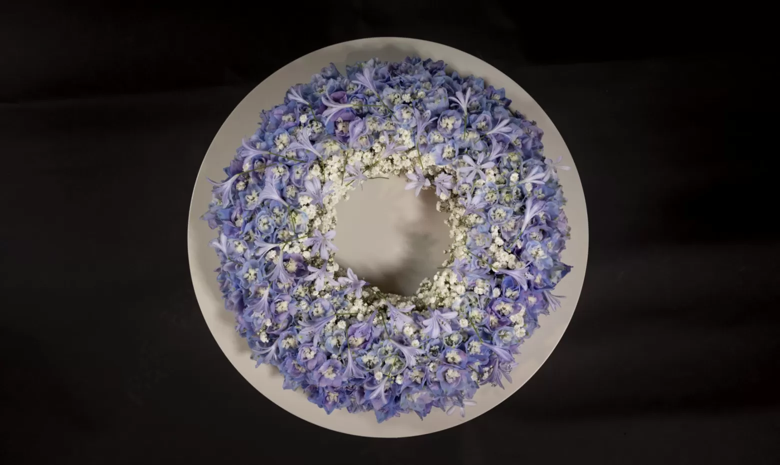 Funeral wreath with Delphinium, Agapanthus and Gypsophila