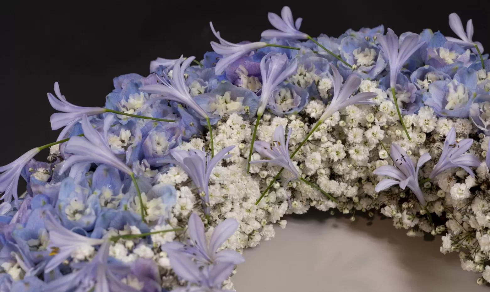 Funeral wreath with Delphinium, Agapanthus and Gypsophila