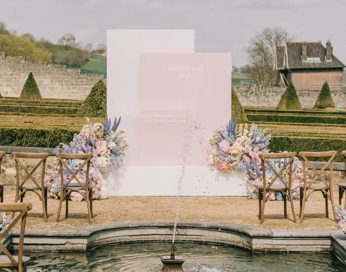 Wedding ceremony backdrop floral arrangement with Delphinium, Clematis Amazing®
